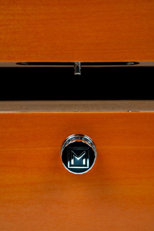 signature M button on the front of Maccarrone World Map Colors Humidor