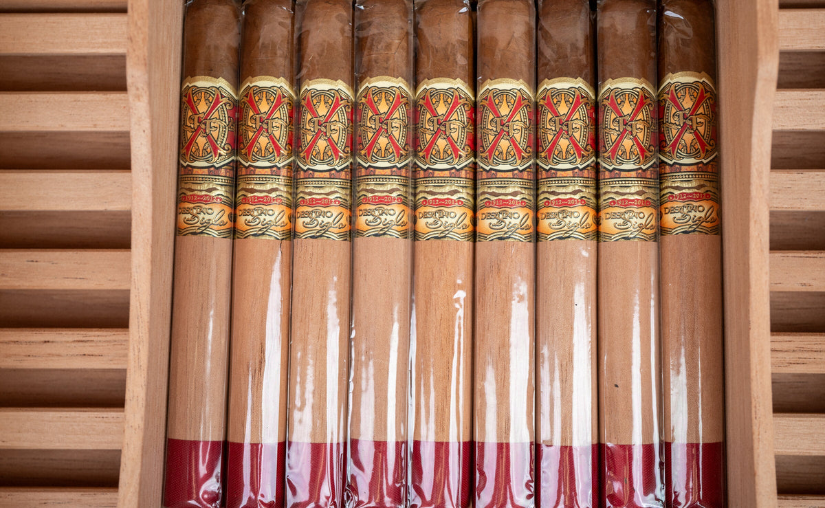 Fuente Fuente OpusX cigars in cellophane resting in a cedar humidor tray
