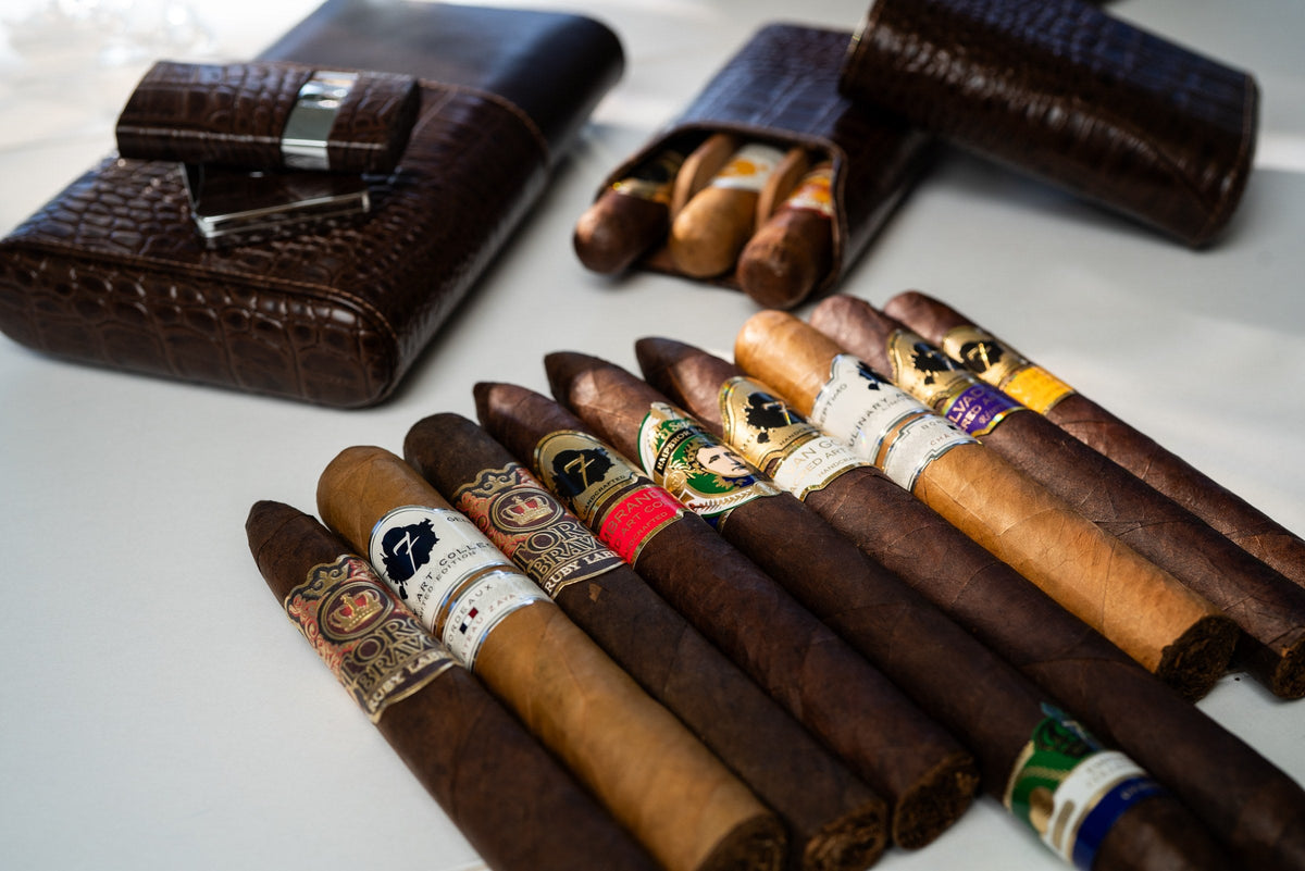 Crocodile-embossed leather cigar cases beside a spread of premium cigars