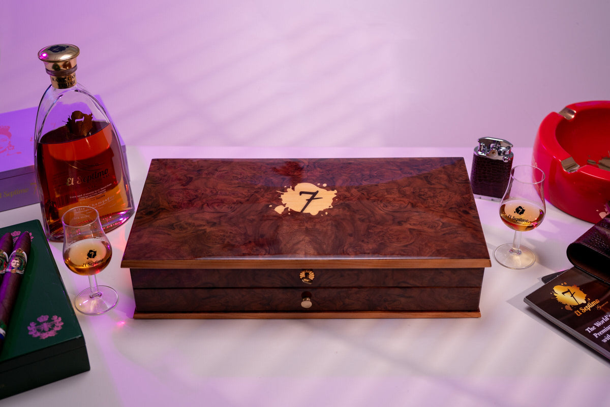El Septimo burl wood presentation box beside a cognac decanter and ashtray