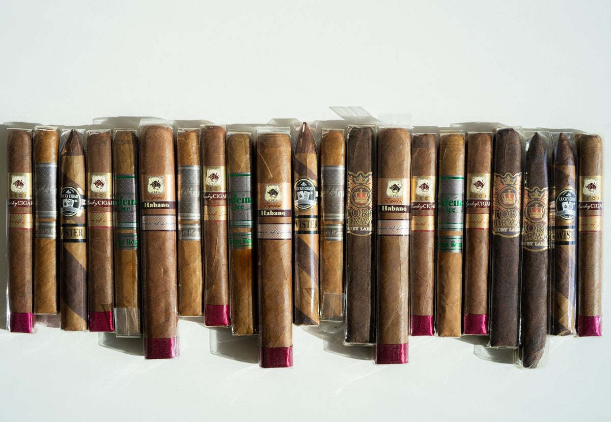 Long row of cellophane-wrapped premium cigars in different sizes and wrapper shades