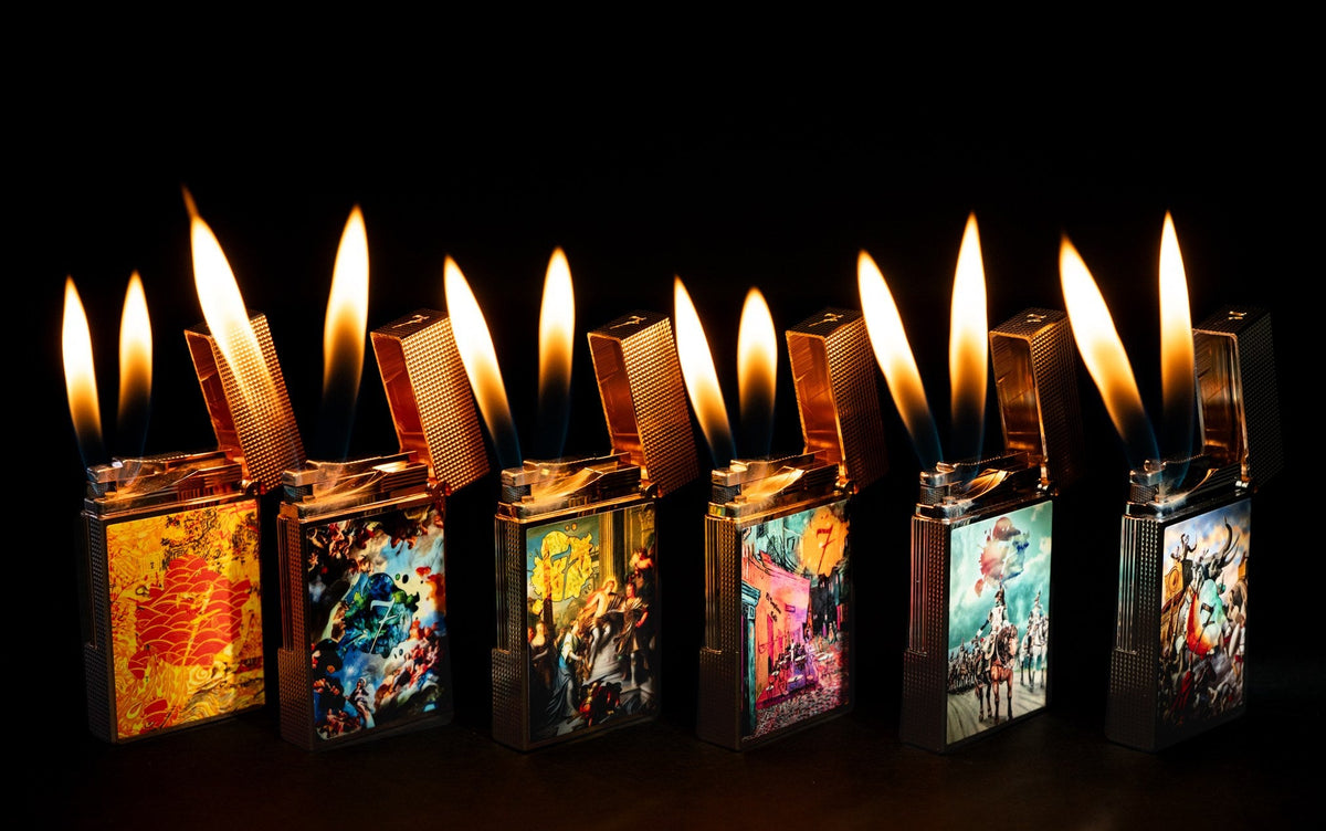 Row of lit soft-flame luxury cigar lighters with hand-painted artwork