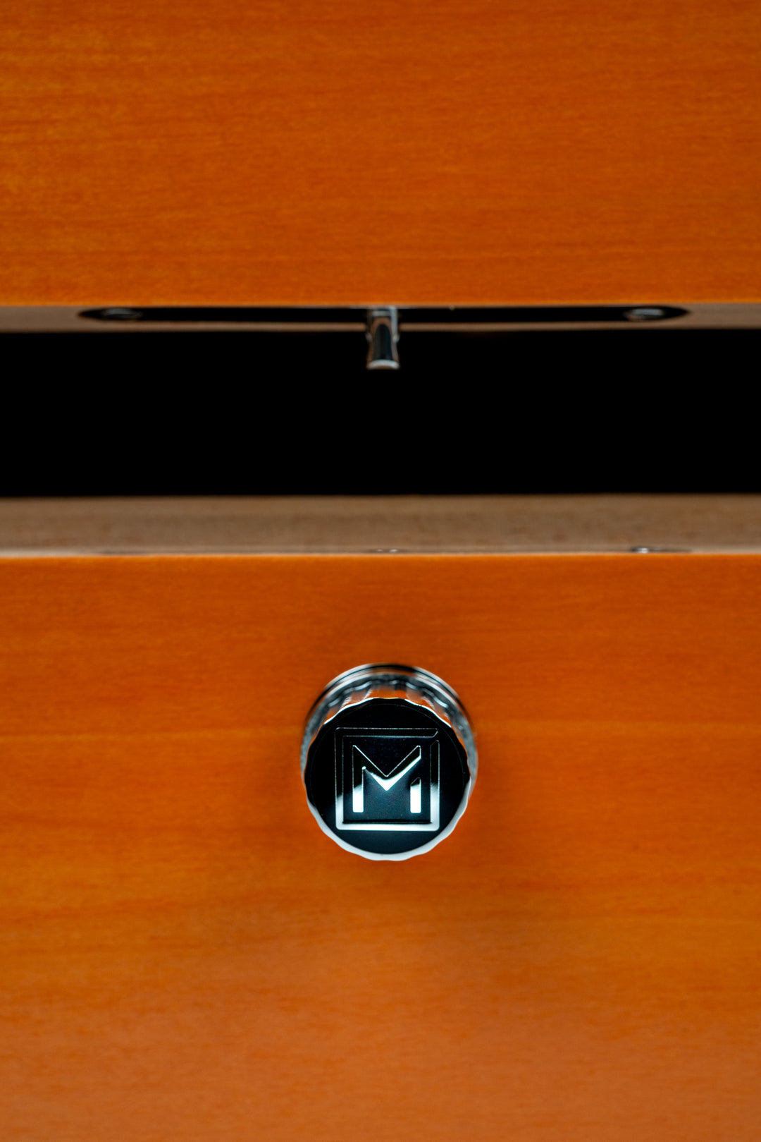 signature M button on the front of Maccarrone World Map Colors Humidor