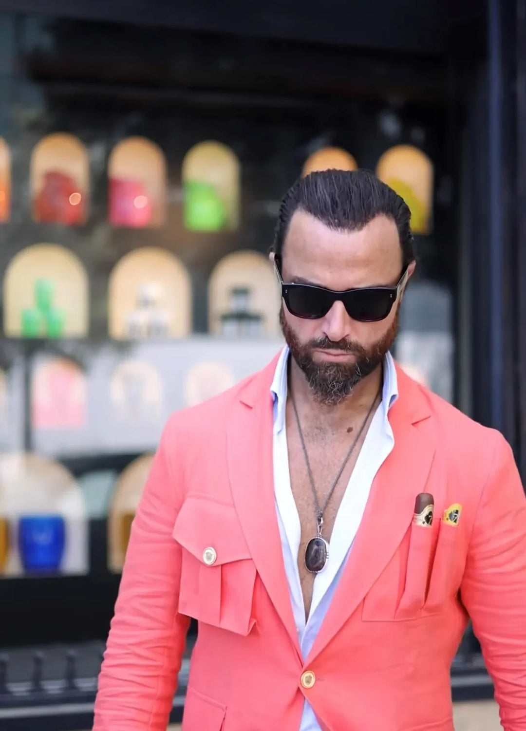 Man wearing an coral colored El Septimo Smoking Suit Jacket with 3 cigar pockets available at Cigar Inc in Woodland Hills, Los Angeles