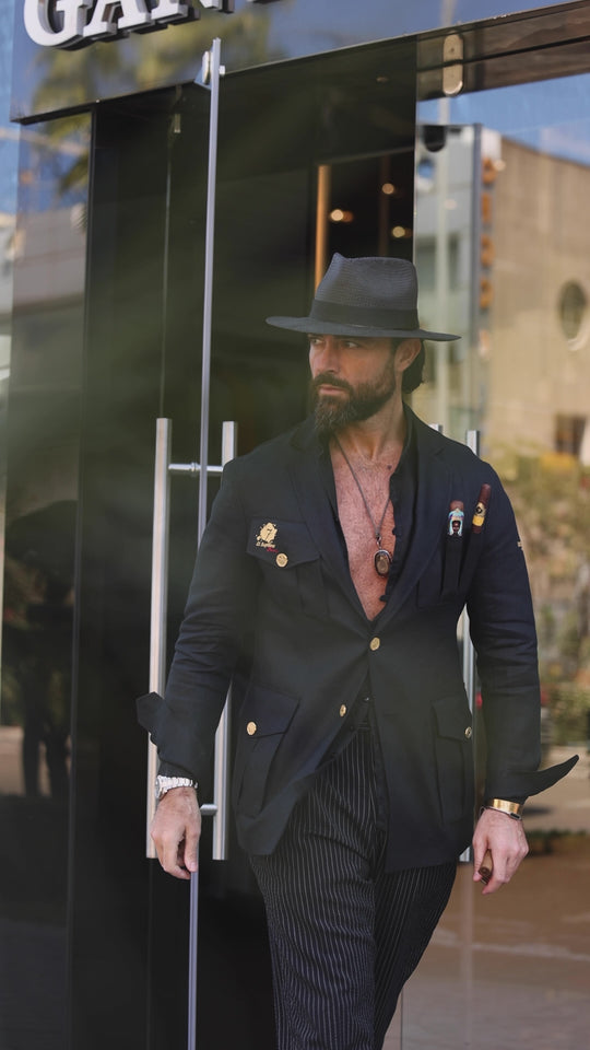 Video of a man walking out of a building wearing a black El Septimo Smoking Suit Jacket with 3 cigar pockets available at Cigar Inc in Woodland Hills, Los Angeles