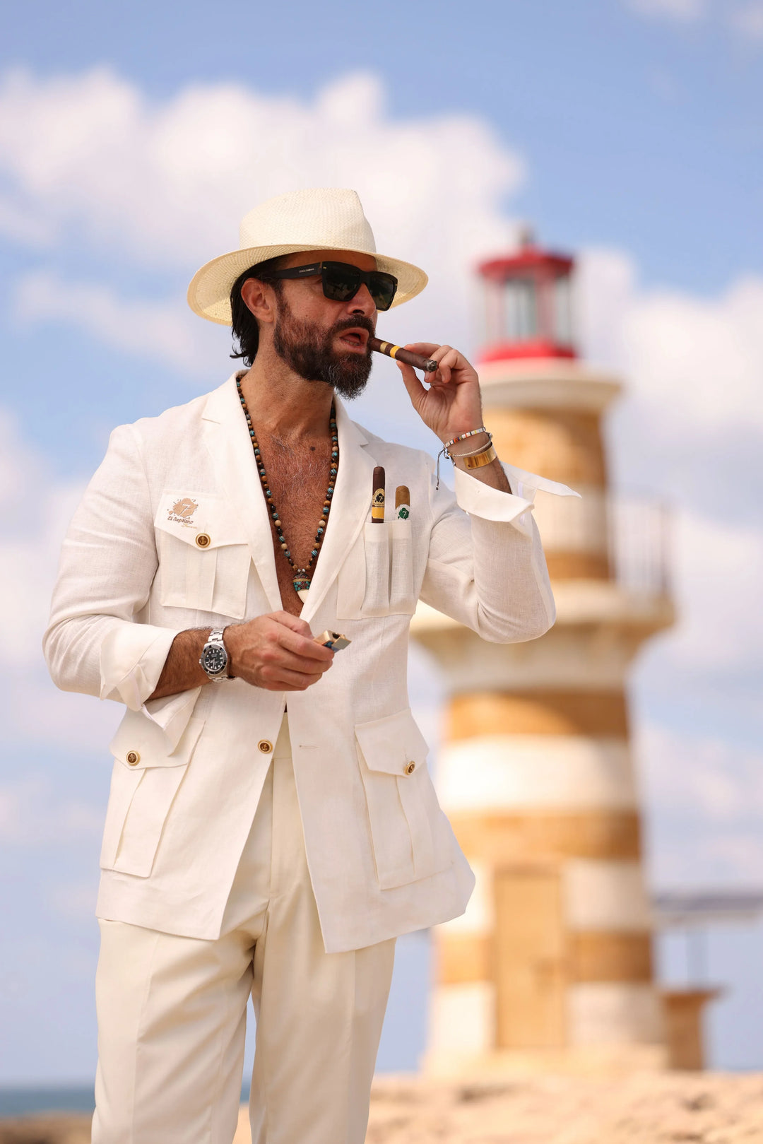 Man wearing a white El Septimo Smoking Suit Jacket with 3 cigar pockets available at Cigar Inc in Woodland Hills, Los Angeles